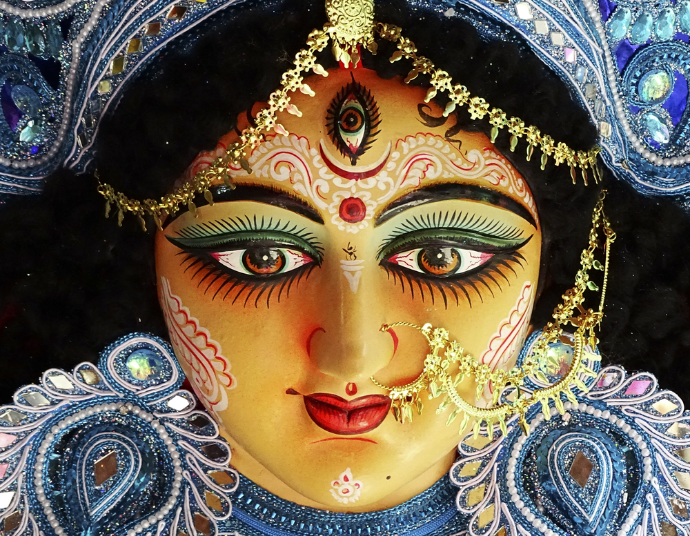 A close up on the face of an idol of Goddess Durga, symbol of strength and intensity as per Hinduism.