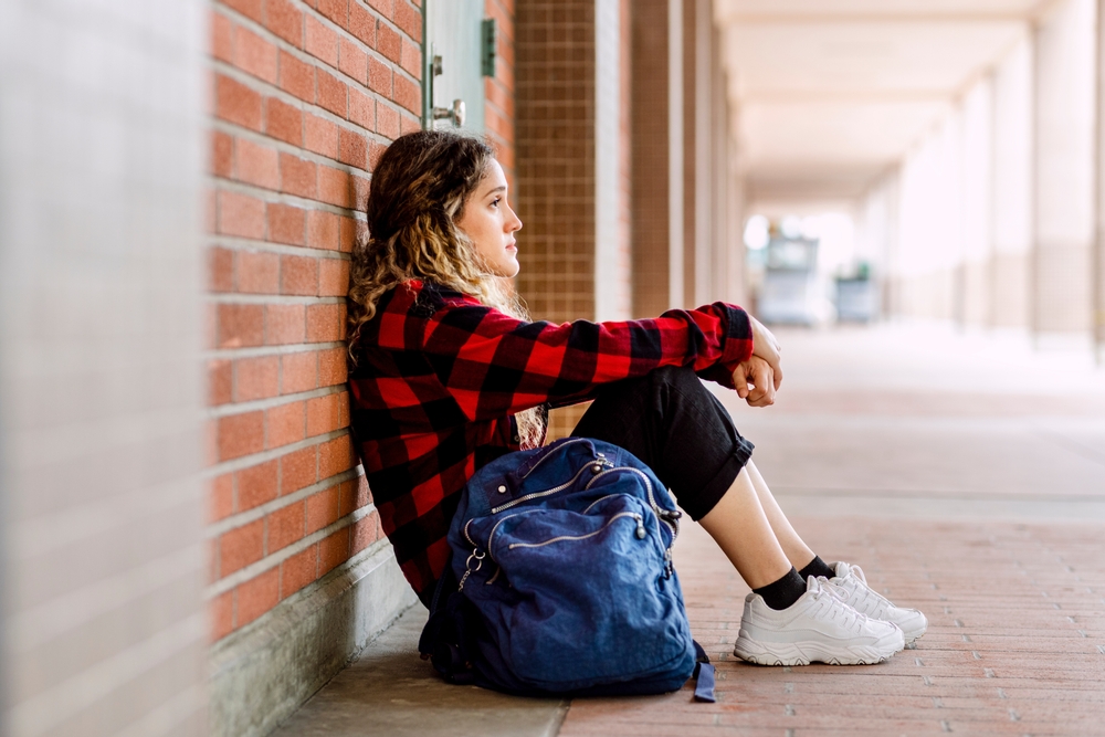Girl sitting alone at school