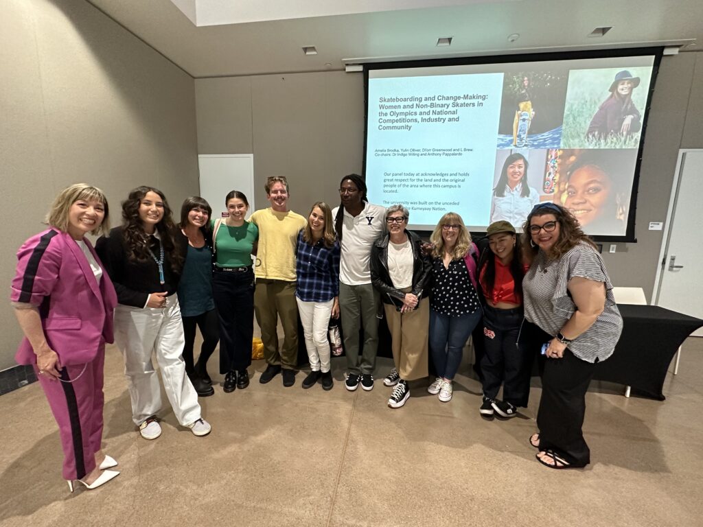 Photo features panellists Yulin Olliver, Di’orr Greenwood, L Brew and Amelia Brodka with Dr Indigo Willing and other speakers at The Stoked Sessions San Diego State University conference, taken by Alec Beck.